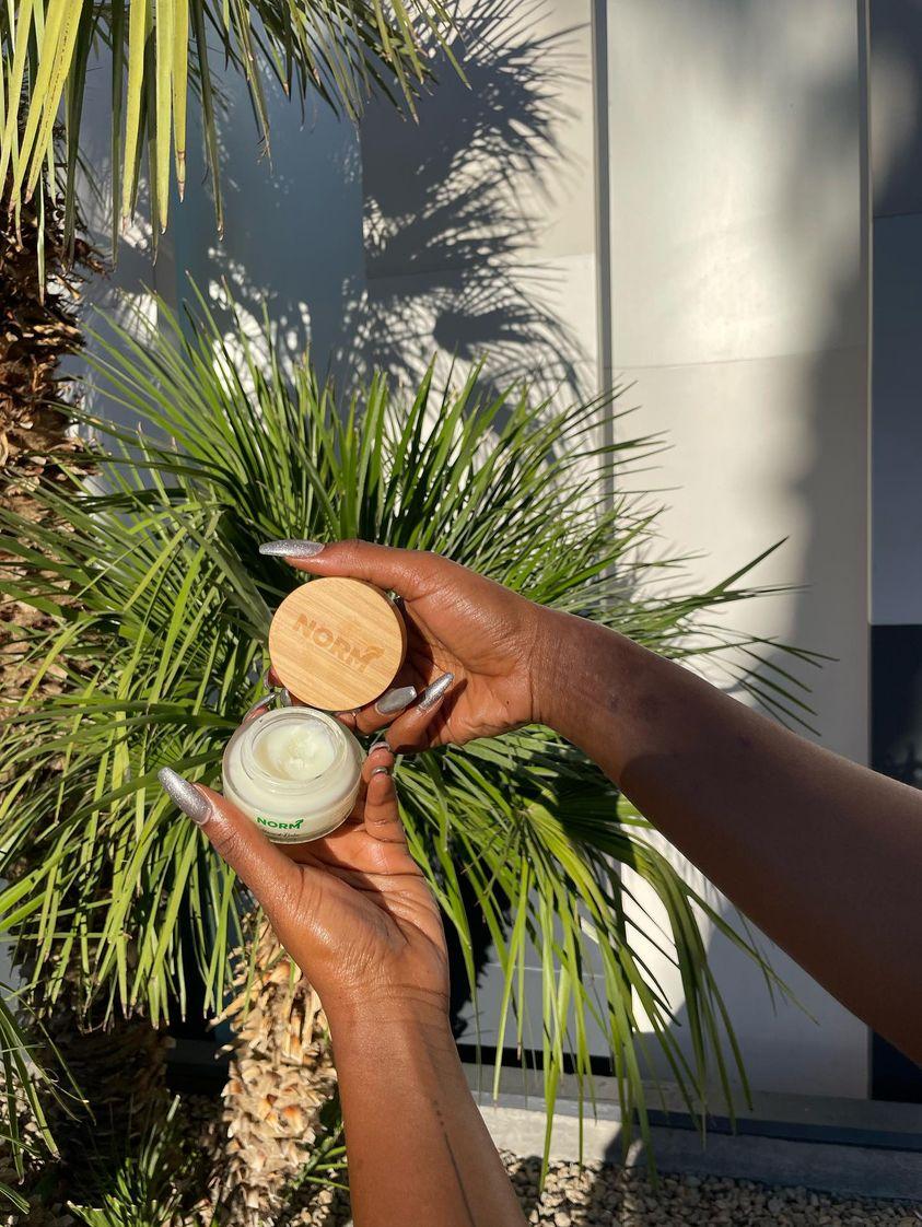 women applying cream to face